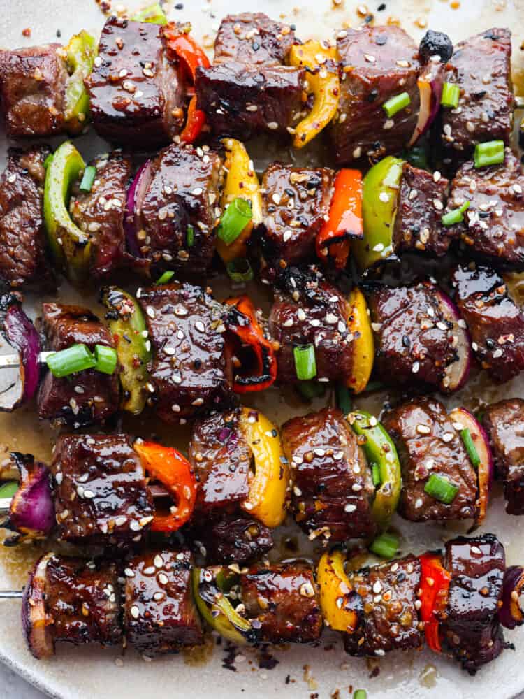 A closeup of cooked Asian garlic steak skewers. 