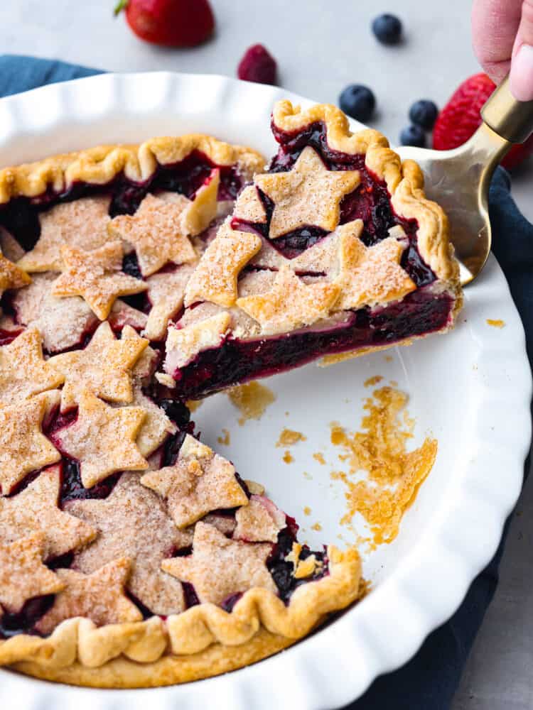 Picking up a slice of pie with a cake spatula.