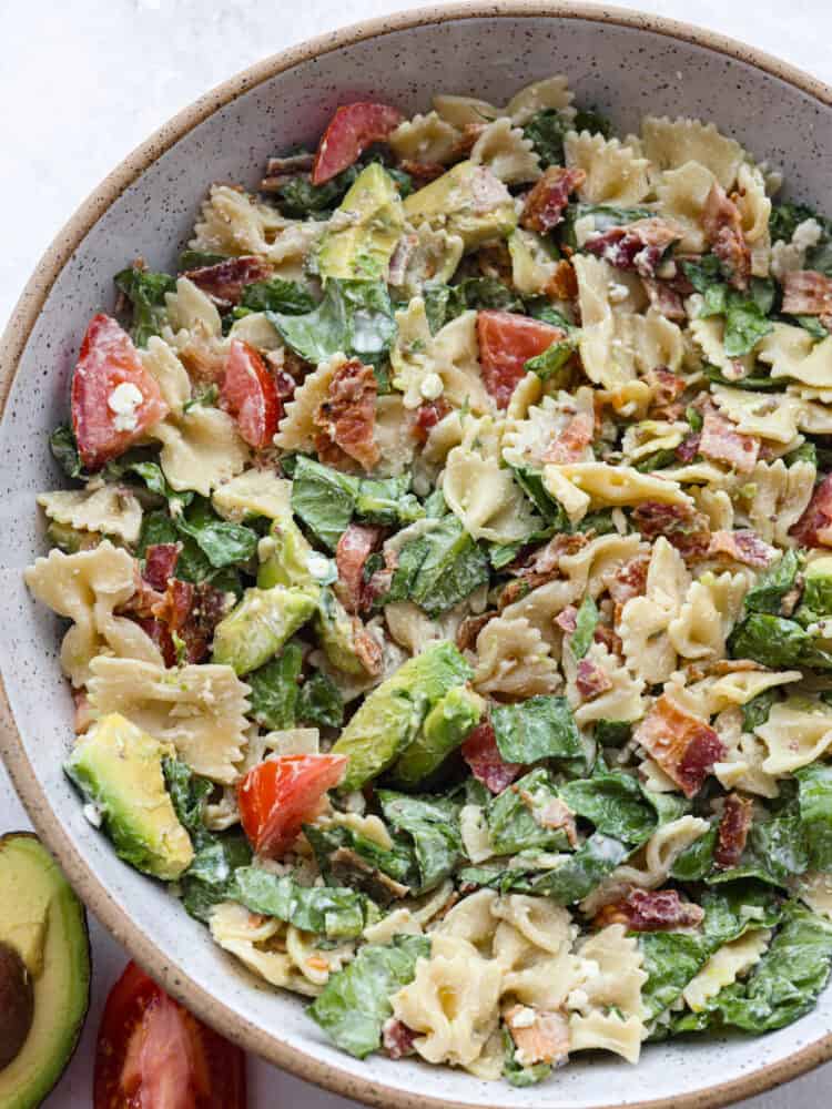 The top view of a bowl of BLT avocado pasta salad. 