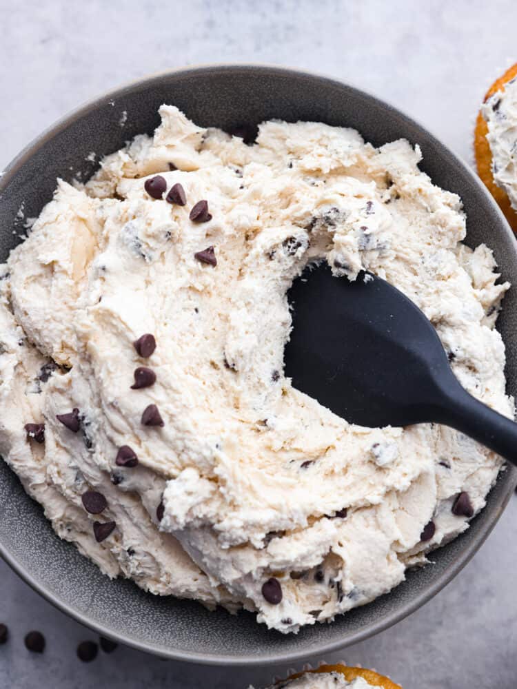 Top-down view of cookie dough frosting in a gray bowl.