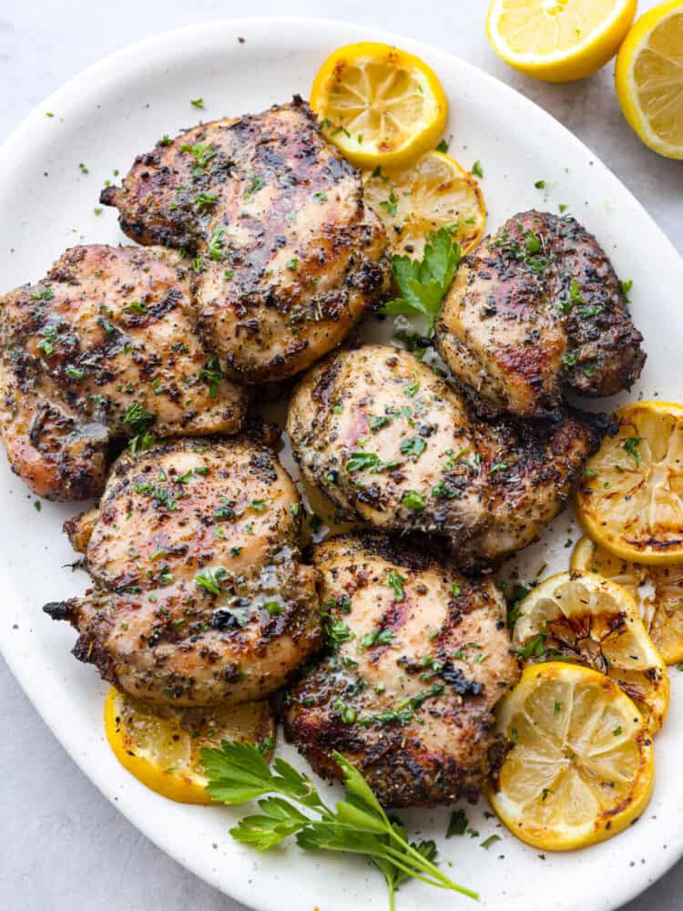 A platter of grilled lemon chicken, ready to serve. 