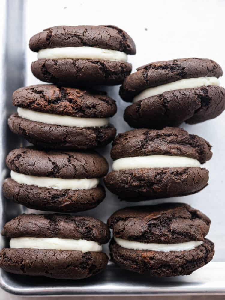 The side view of seven oreo cakesters on a cookie sheet. 