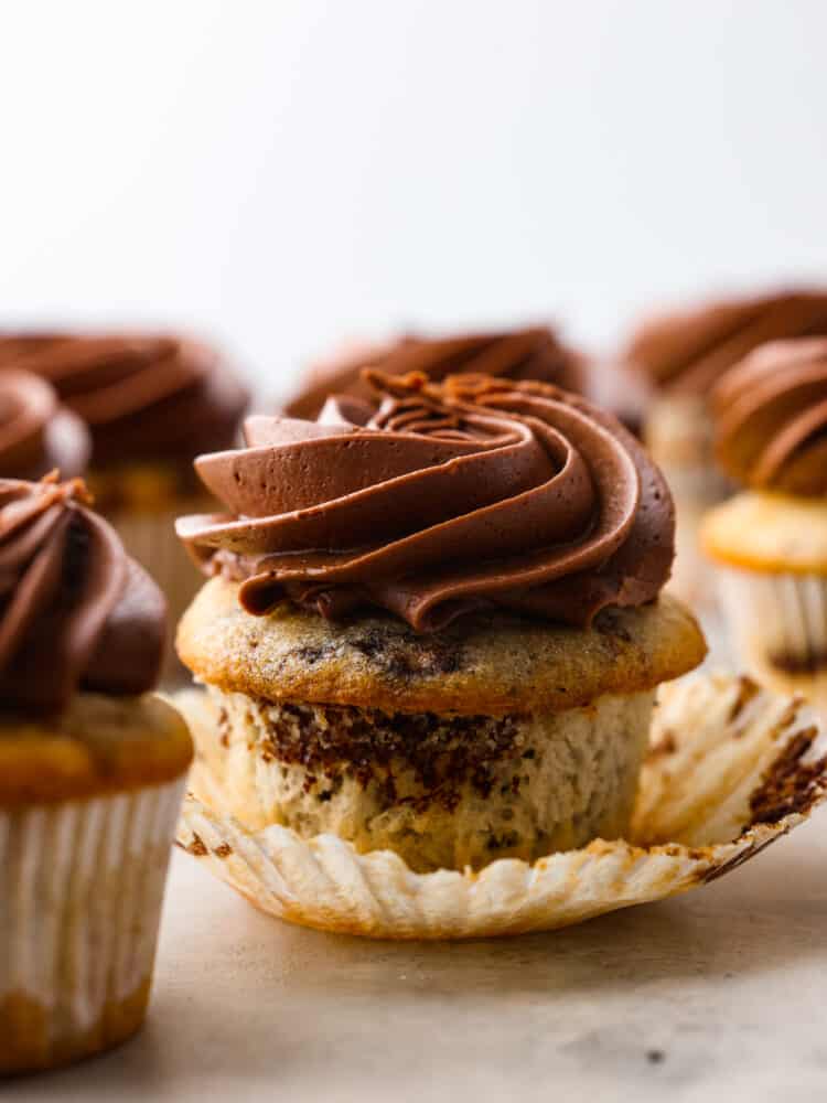 The side view of a marble cupcake with chocolate buttercream frosting. 