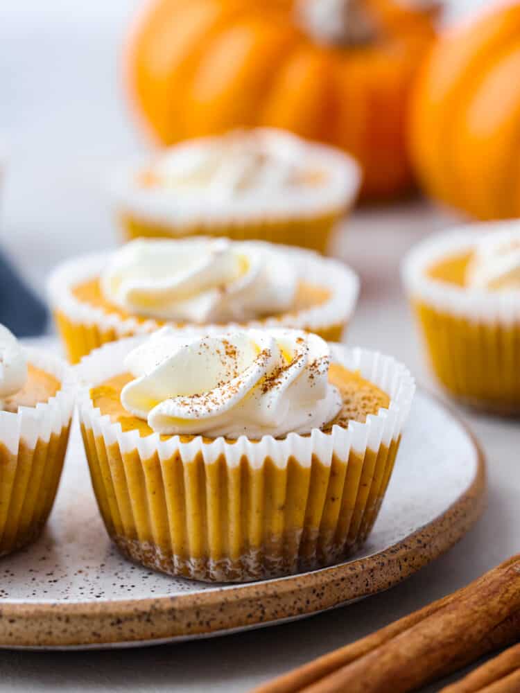 Closeup of a mini pumpkin cheesecake served on a stoneware plate.