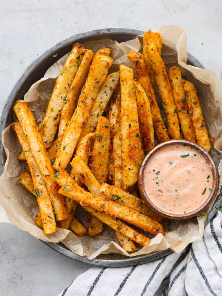 Top-down view of jicama fries served with fry sauce.