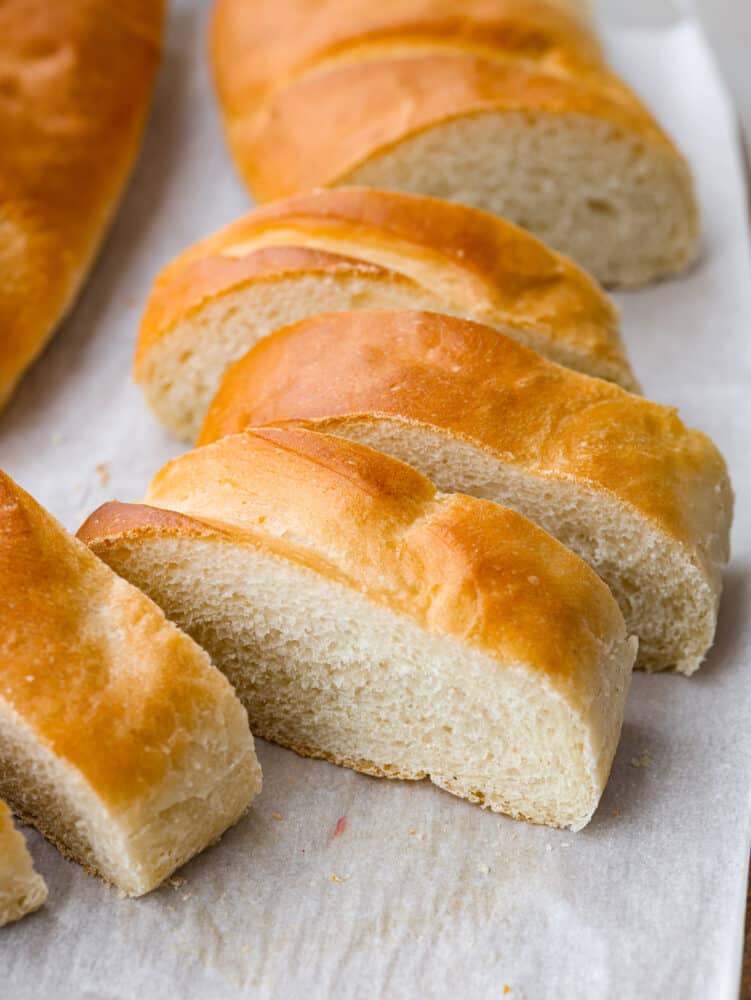 Sliced French bread on parchment paper.