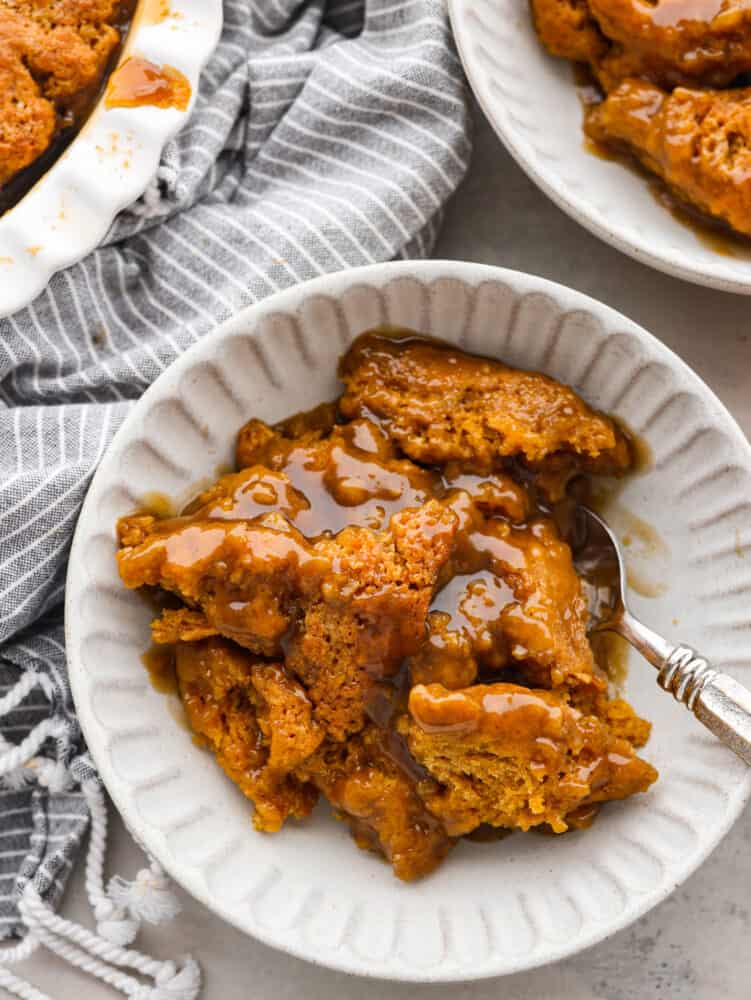 Top-down view of pumpkin pudding cake topped with caramel sauce.