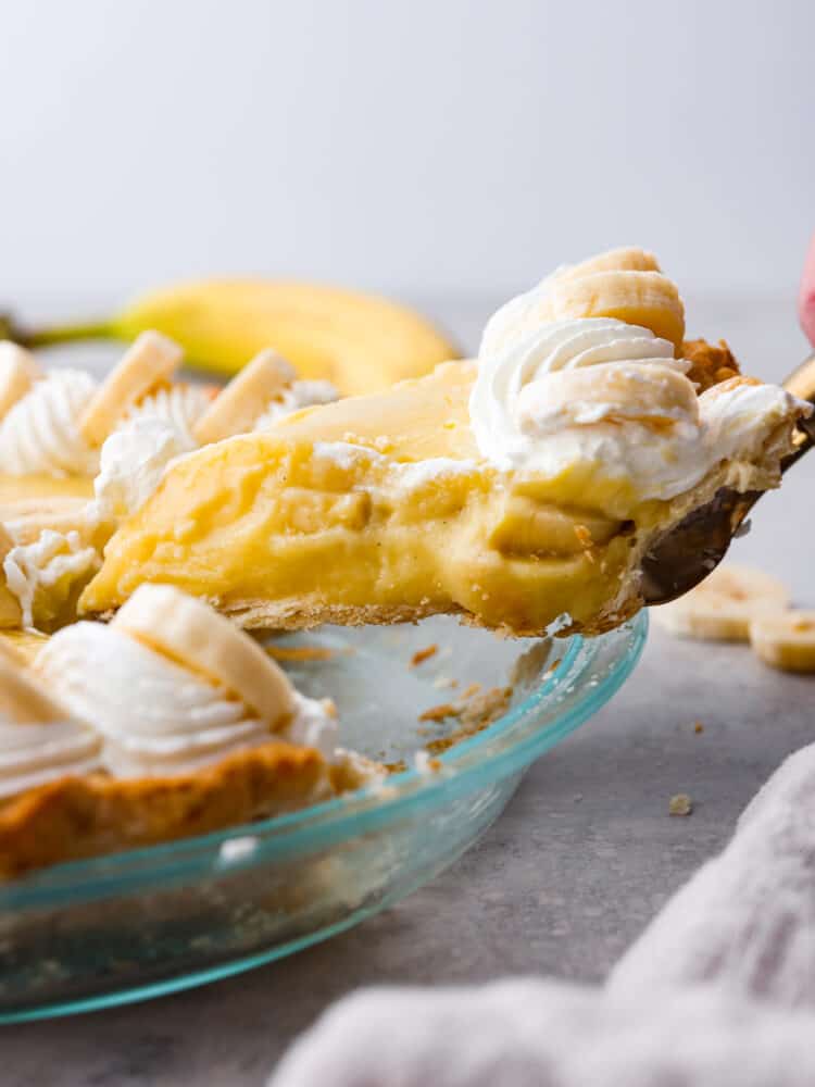 Picking up a slice of pie with a cake spatula.