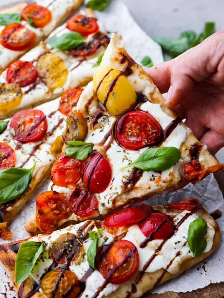 Closeup of a slice of caprese flatbread.