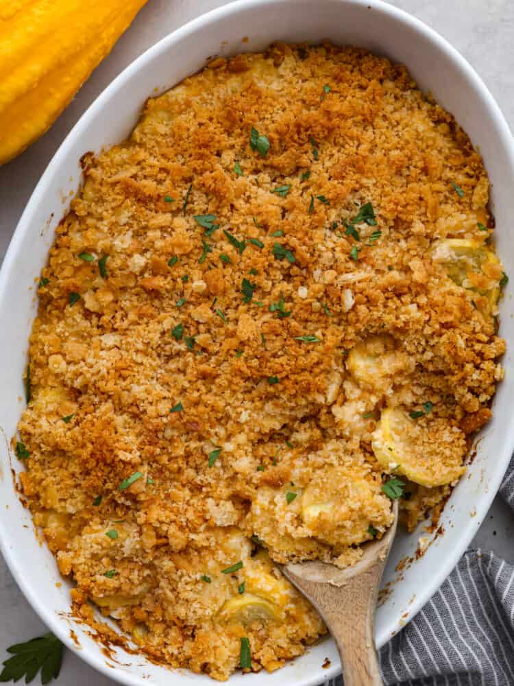 A casserole dish wil cooked squash casserole. 