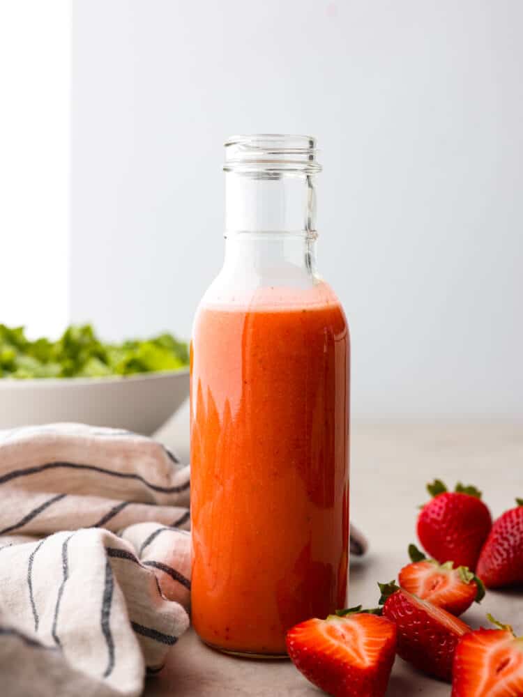 A glass bottle of strawberry vinaigrette. 