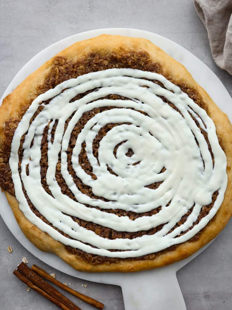 The top view of a cinnamon roll dessert pizza. 