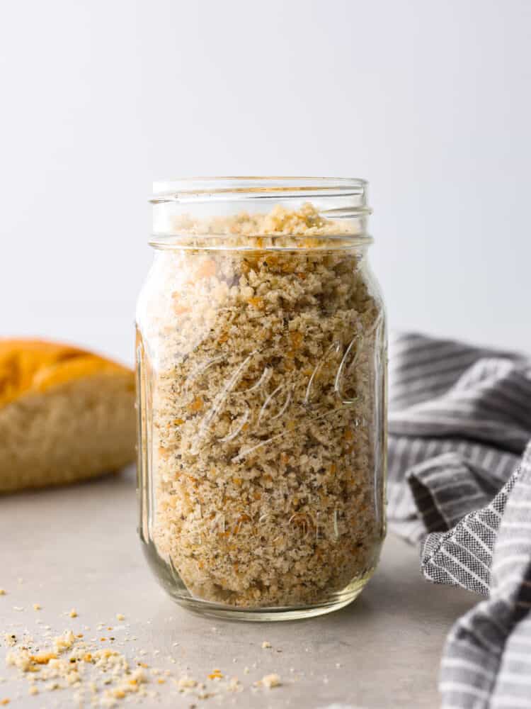 A glass jar filled to the brim with homemade breadcrumbs.