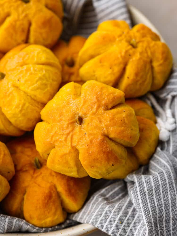 A closeup of a pumpkin dinner roll. 