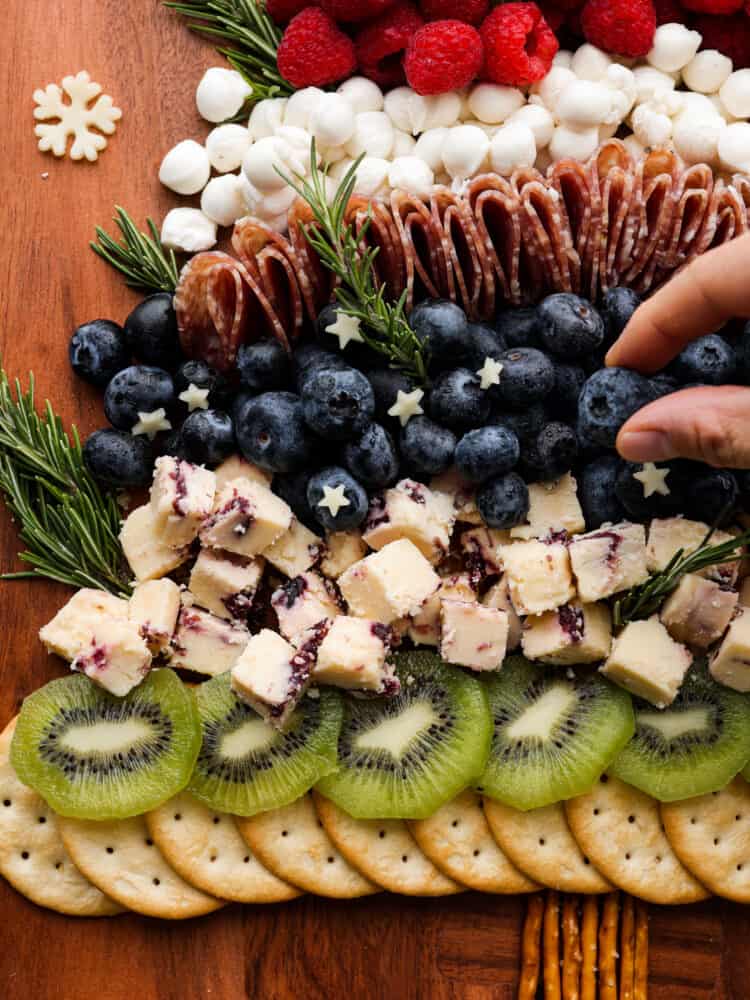 Closeup of cheese and berry layers on charcuterie board.