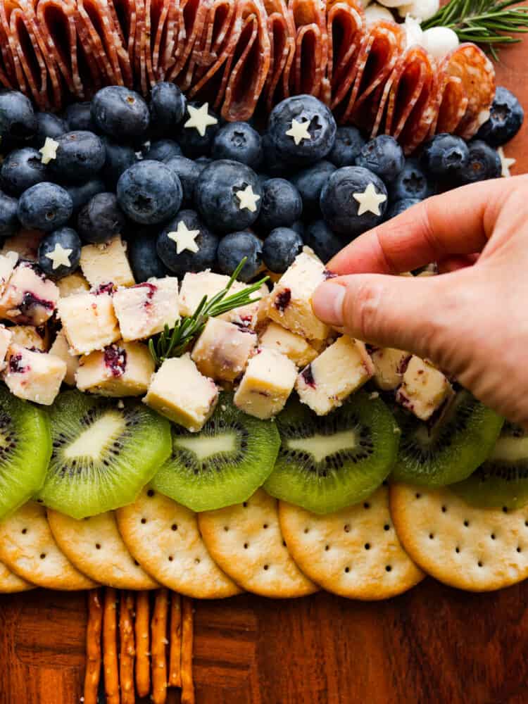 Adding cubes of Wensleydale cheese to the charcuterie board.