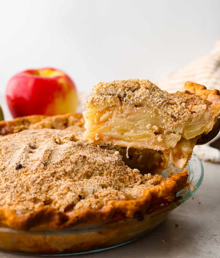 A slice being cut out of the pie and lifted out with a cake spatula.