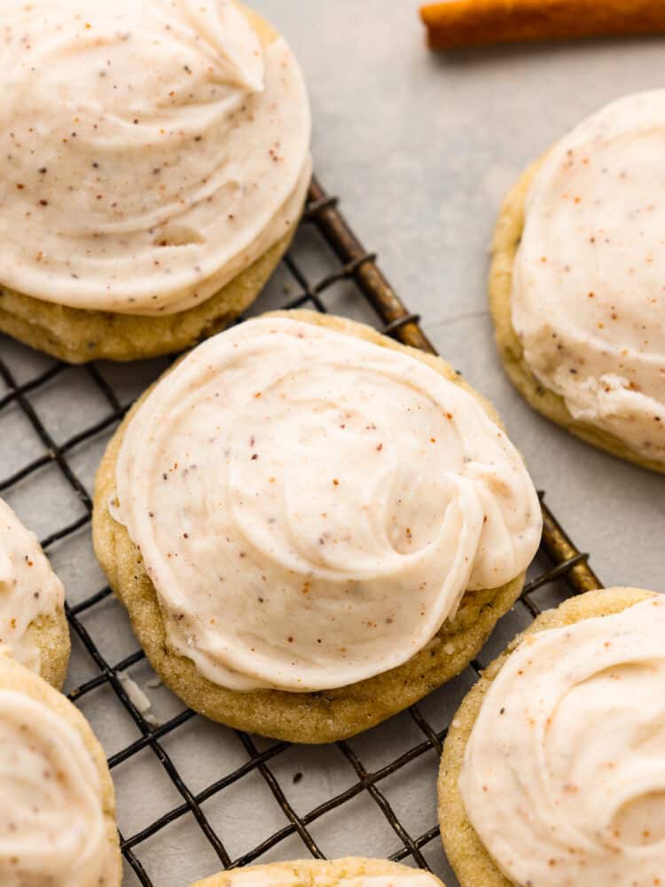 Taylor Swift Chai Sugar cookies with nutmeg frosting sitting on a wire rack with a grey background