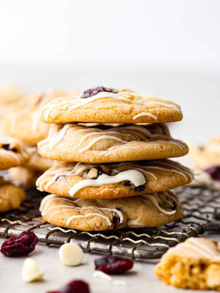 A stakc of cherry cranberry cookies on a cooling rack. 