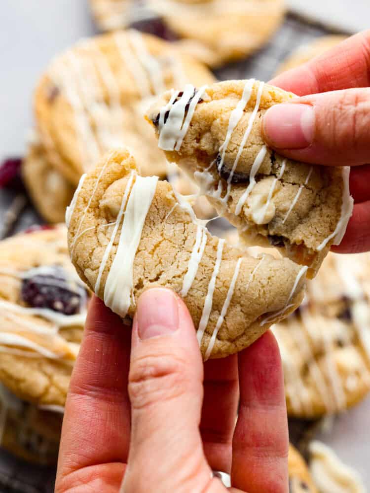 A cookie being broken apart. 