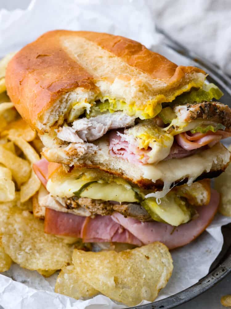 A Cuban sandwich on a plate with a bite taken out. 