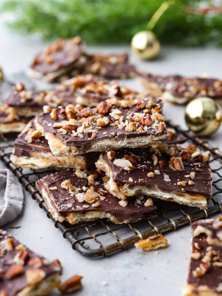 Christmas crack toffee on top of a wire rack with ornaments in the background.