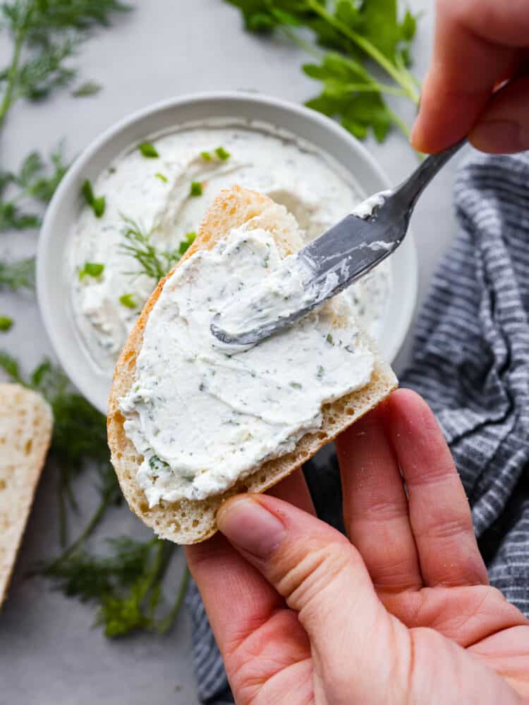 Cream cheese spread over the top of bread.