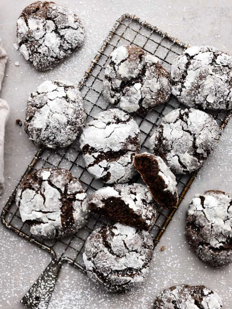 Overhead view of cookies on a cooling rack and dusted with powdered sugar.