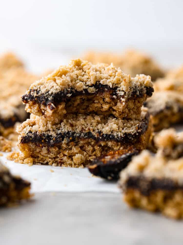 Fig bars stacked on top of each other and the top one has a bite taken out of it.