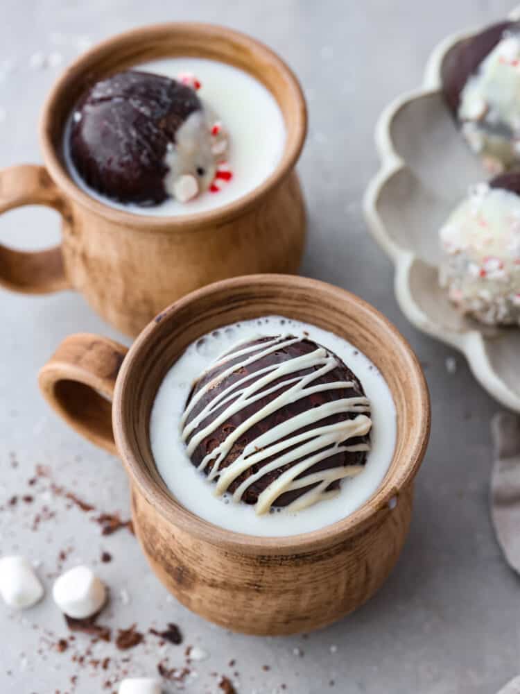 A hot chocolate bomb in a mug filled with milk.