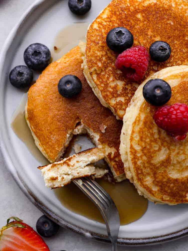 Closeup of keto pancakes with a bite taken out of them.