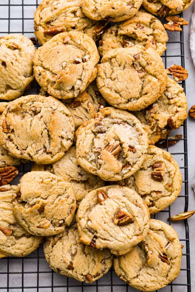 Top-down view of butter pecan cookies on a cooling rack.