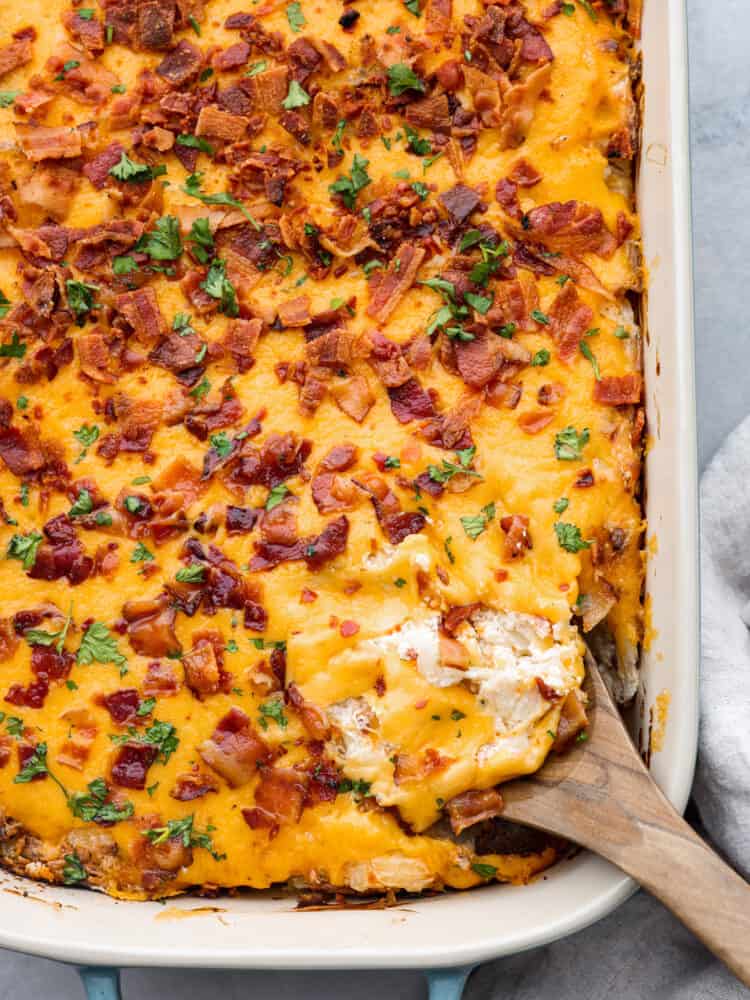 Top-down view of crack potatoes in a casserole dish.