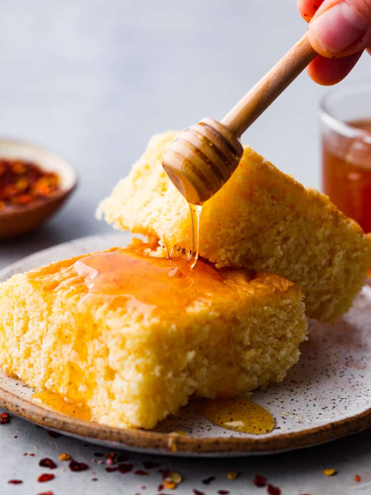 Drizzling honey over cornbread.