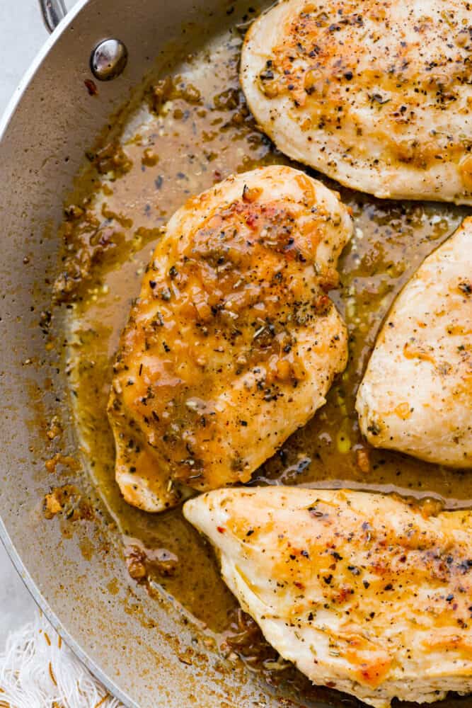 A close up on the chicken in the pan.