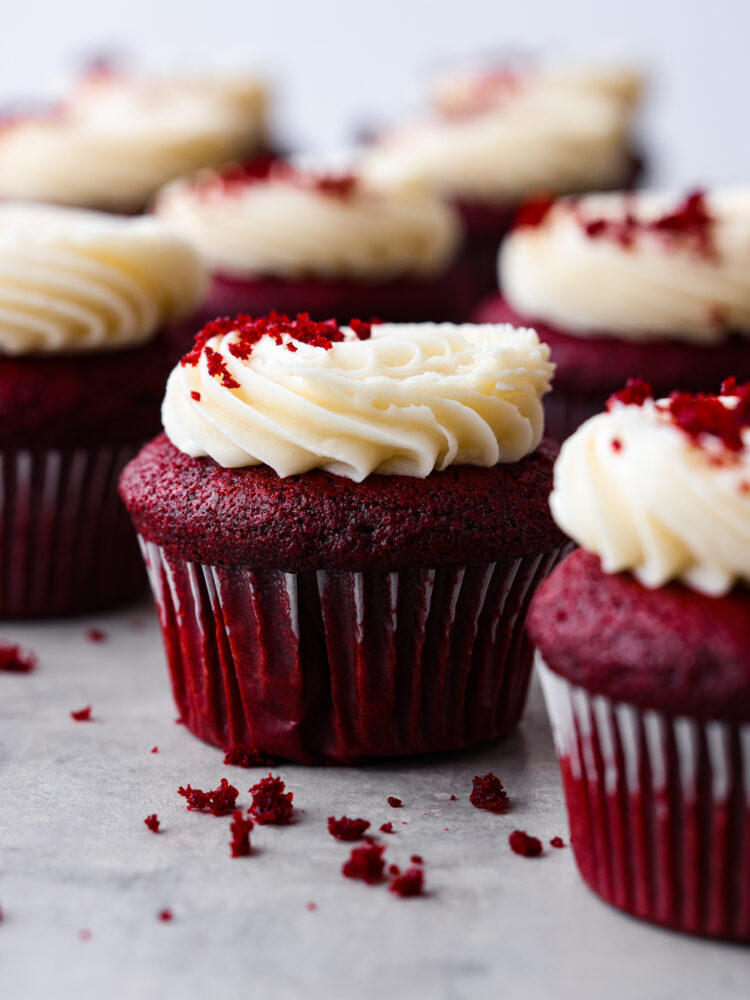 Hero image of red velvet cupcakes topped with cream cheese frosting.