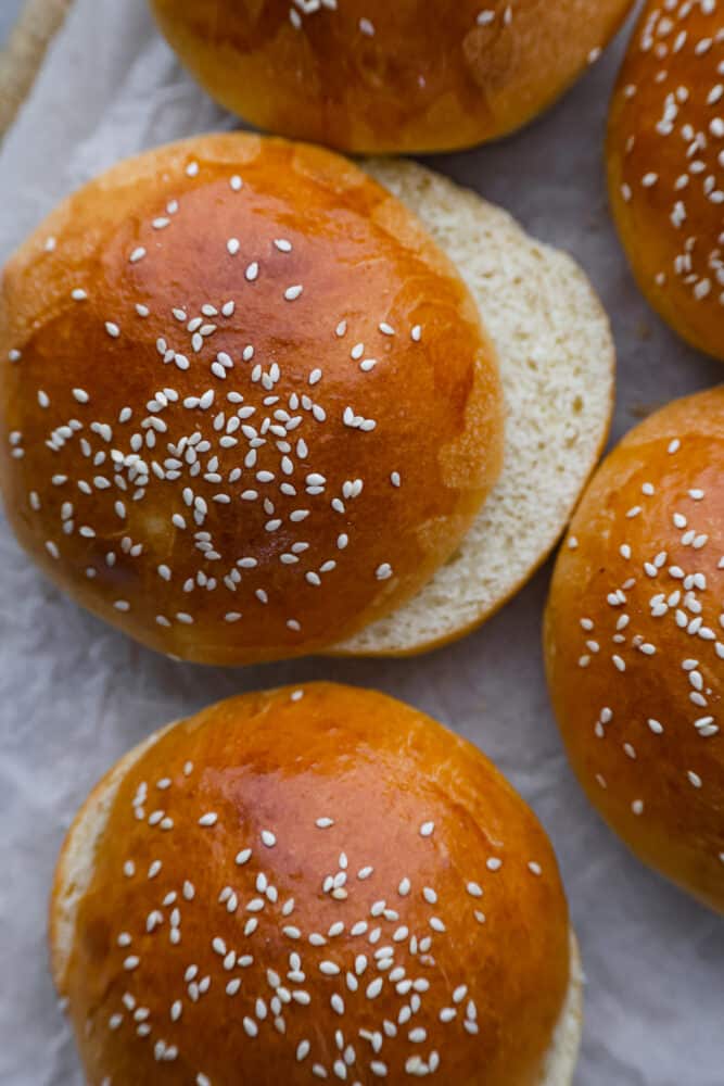 A close up on a brioche bun that has been sliced open.