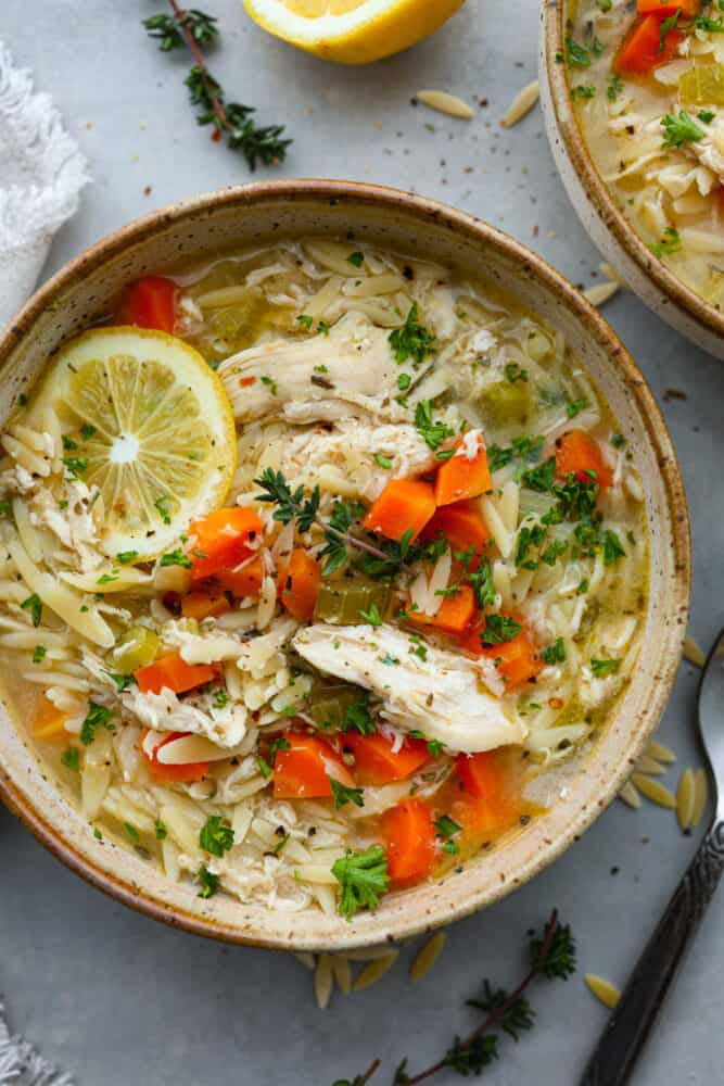 Lemon chicken orzo soup in a bowl.