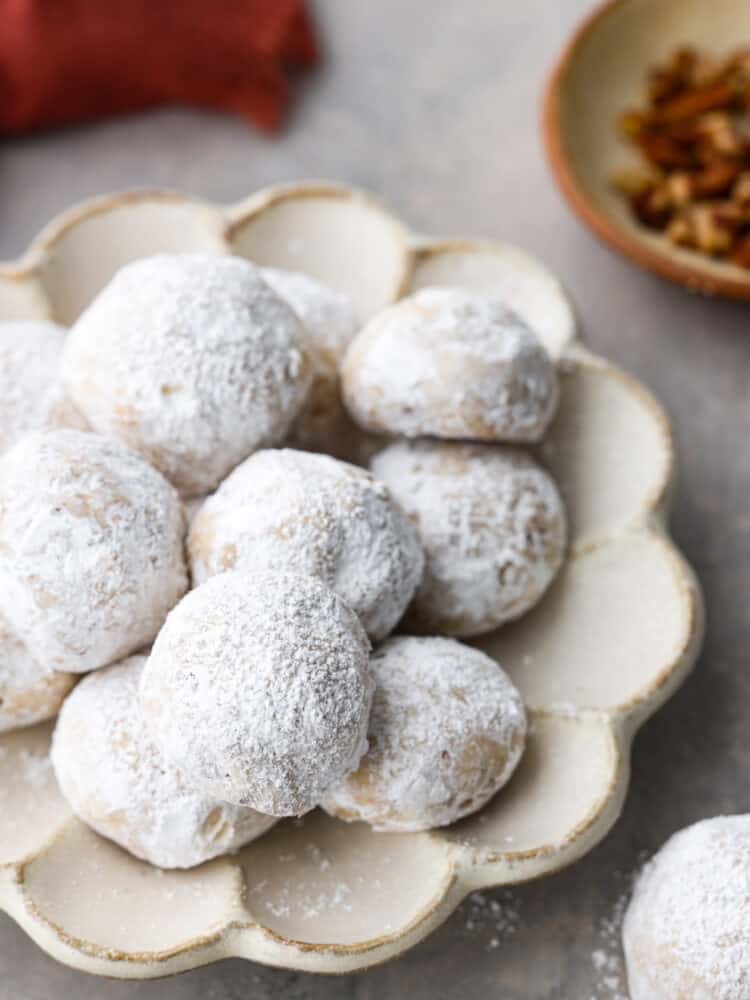 The cookies on a scalloped white plate.