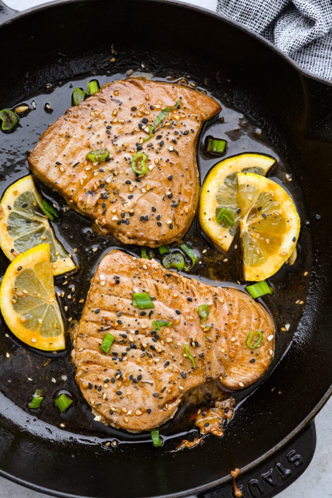 Seared tuna steaks in a pan.