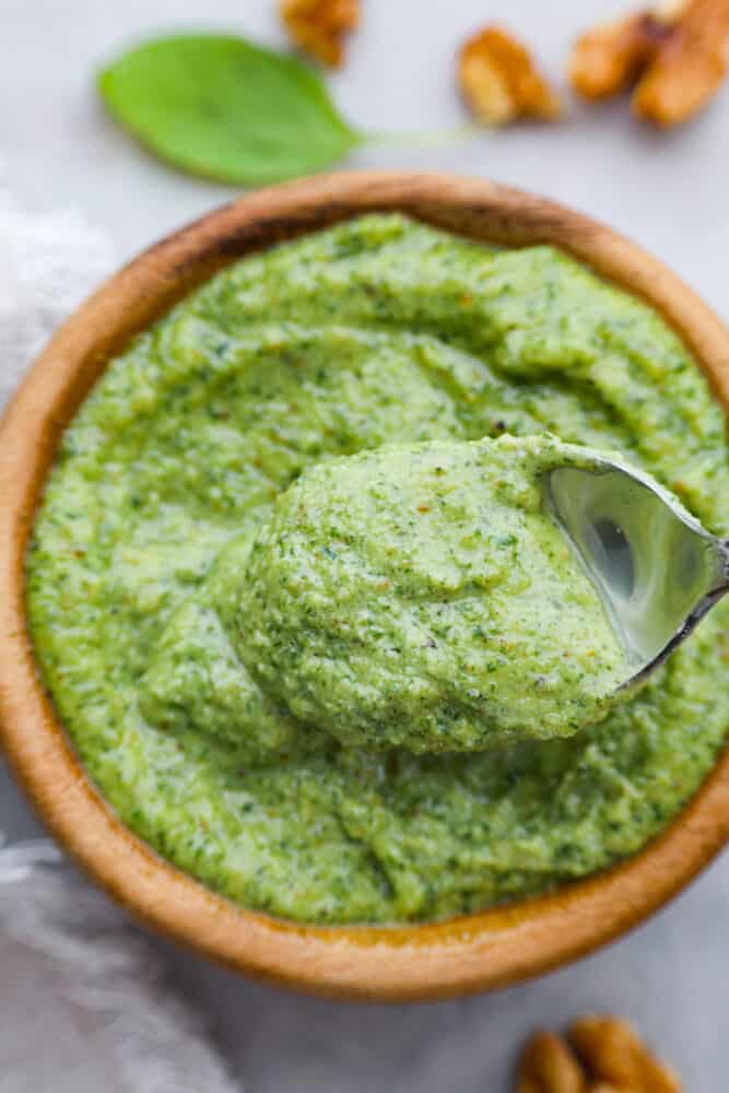 Closeup of a spoonful of pesto.