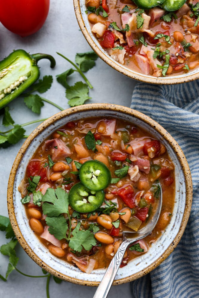 Charro beans in a bowl with a spoon.