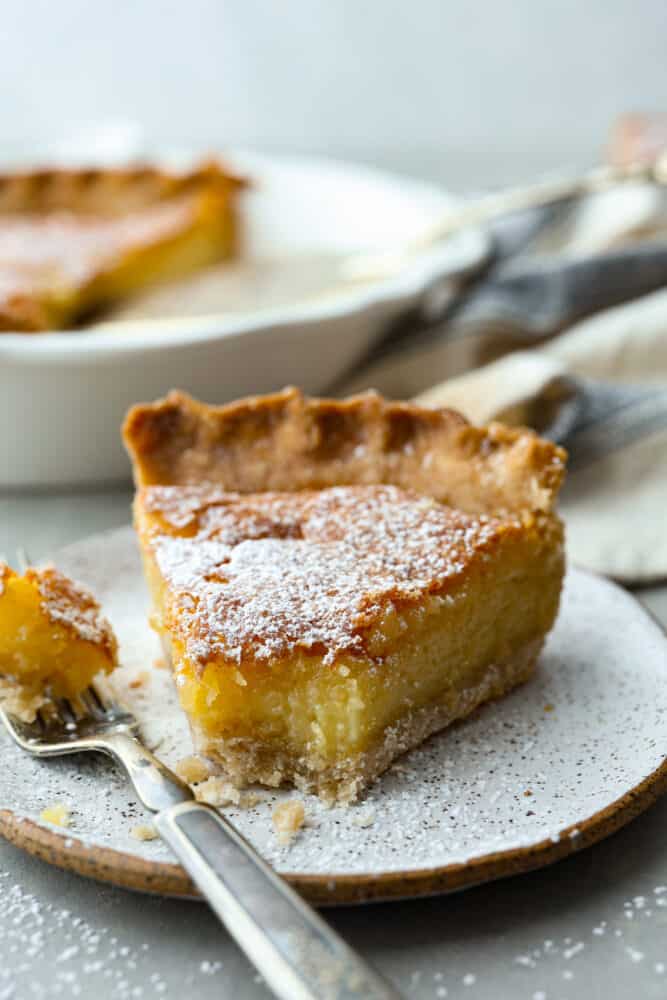 Front view of a slice of pie with a bite taken out of it.