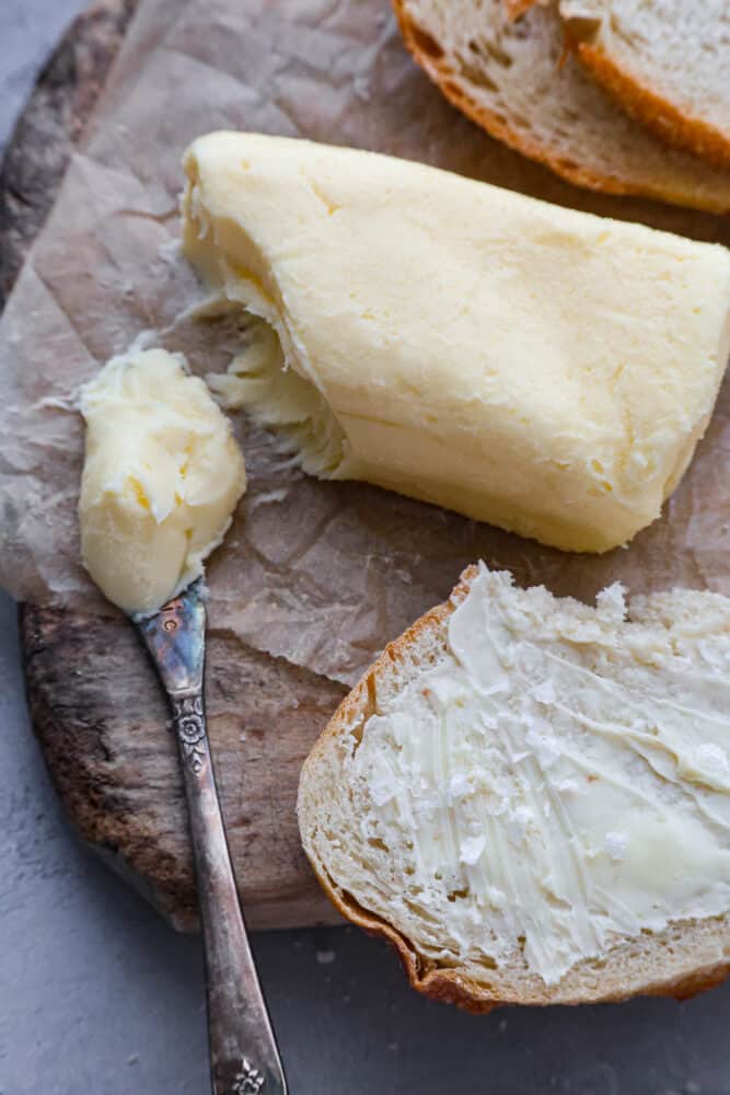 An overhead view of homemade butter and some spread on a piece of bread.