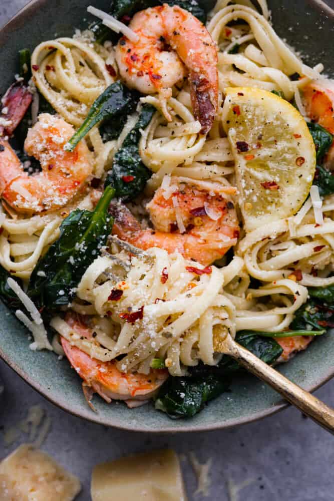 A close up on lemon garlic parmesan shrimp pasta in a bowl.