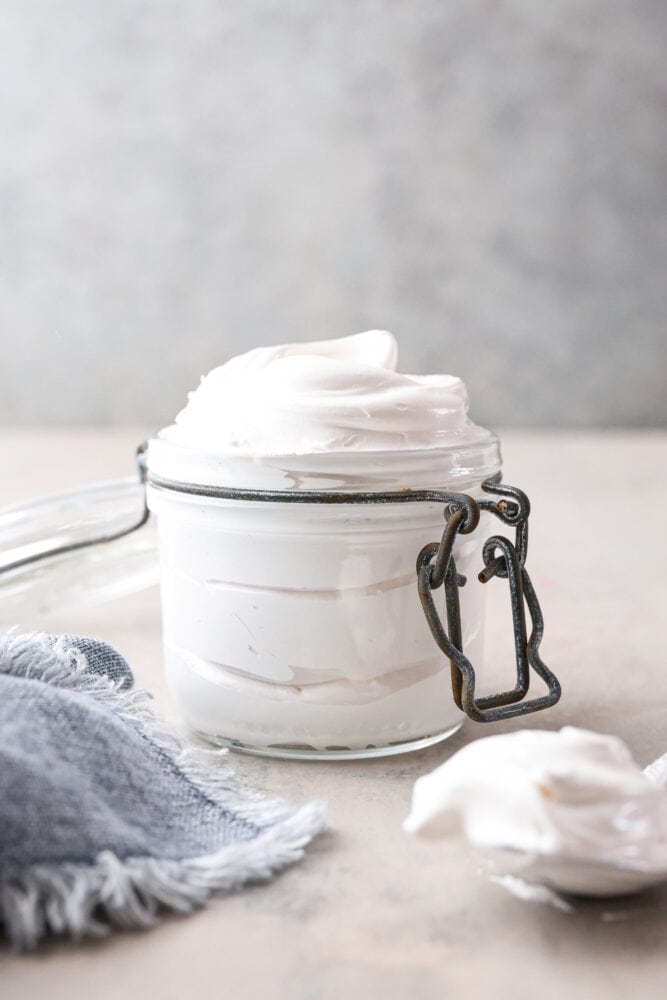 Front view of homemade marshmallow fluff in a glass jar.