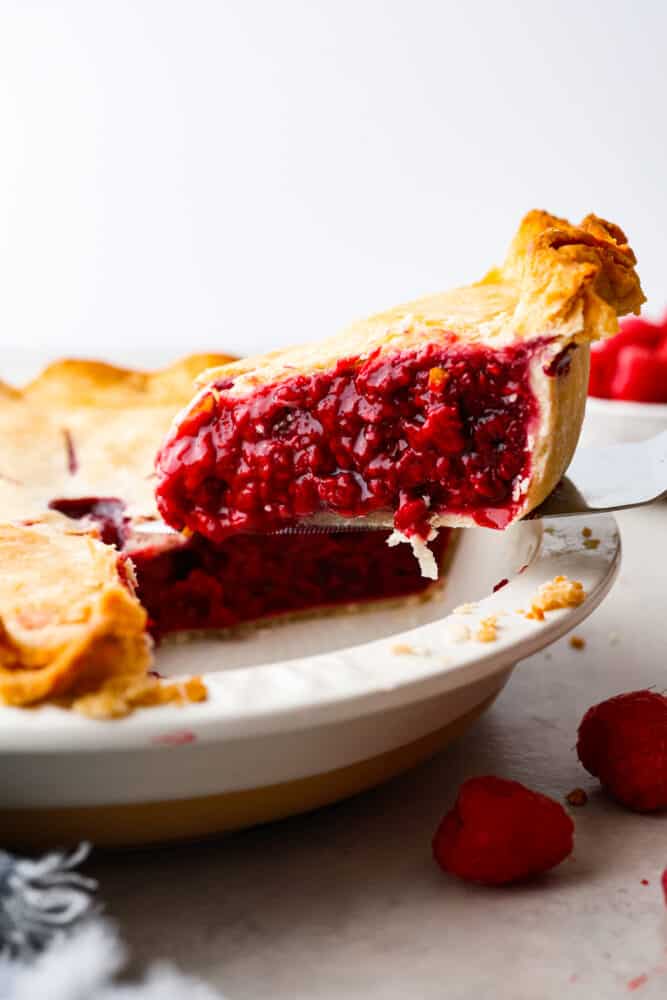 A slice of pie being served with a cake spatula.