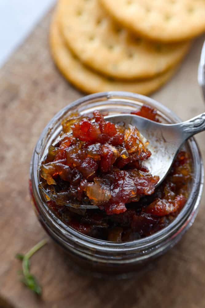 Closeup of bacon jam on a metal spoon.