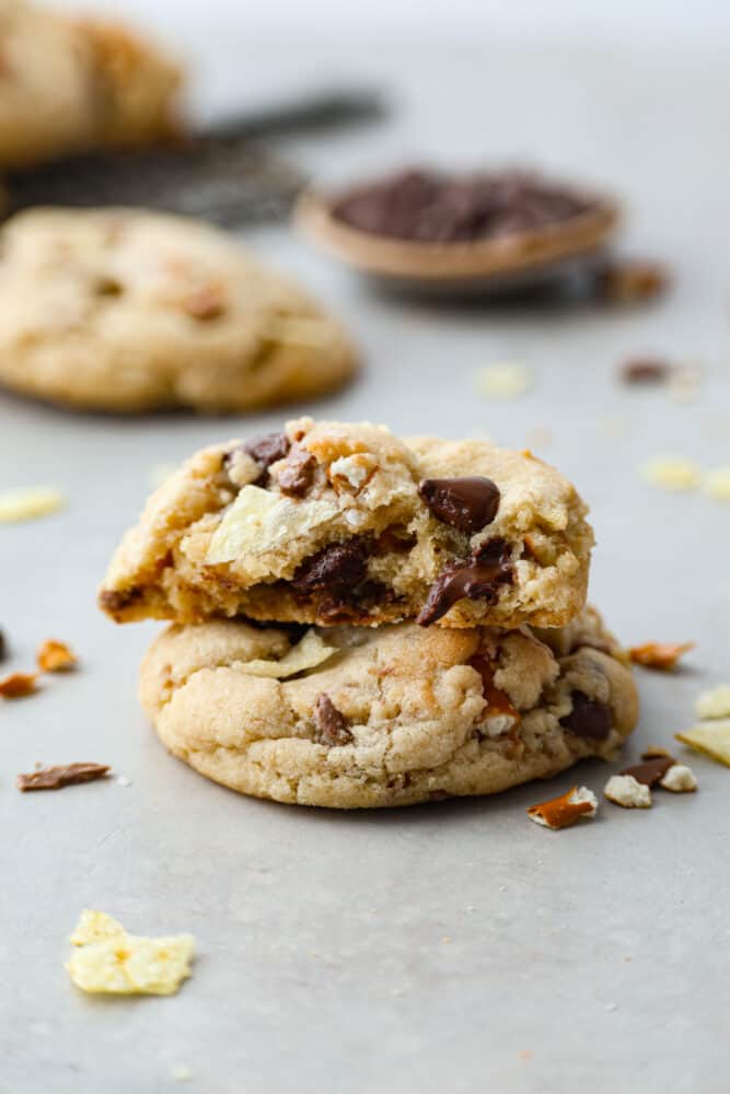 A kitchen sink cookie broken in half stacked on top of each other.