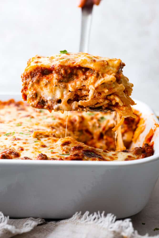 Million dollar spaghetti slice being lifted out of the casserole dish.